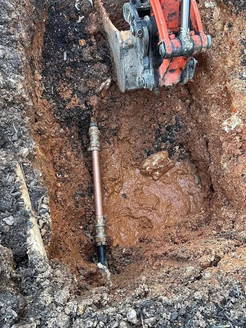 Copper water line repair in an excavated trench
