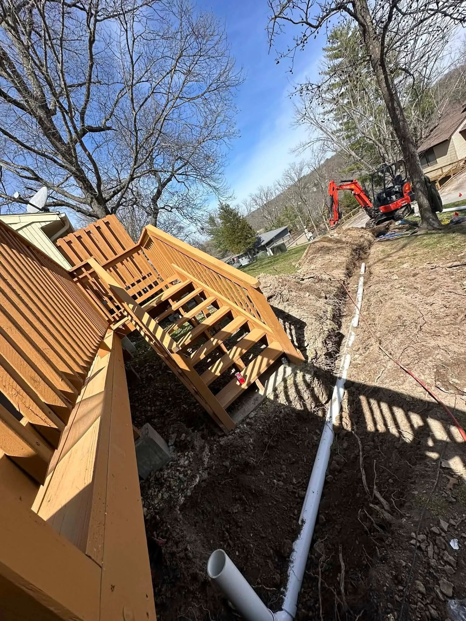 New PVC drain line laid in a prepared trench